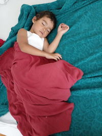 High angle view of baby lying on bed