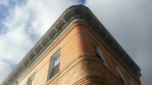 Low angle view of building against cloudy sky
