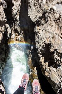 Low section of person standing on rock formation