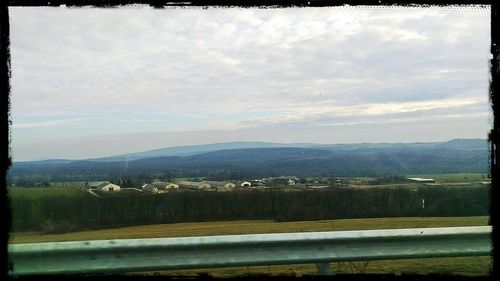 Scenic view of mountains against cloudy sky