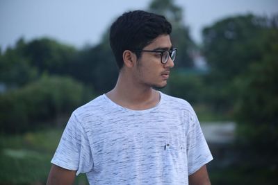 Young man wearing sunglasses standing outdoors