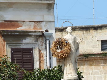 Low angle view of statue against building