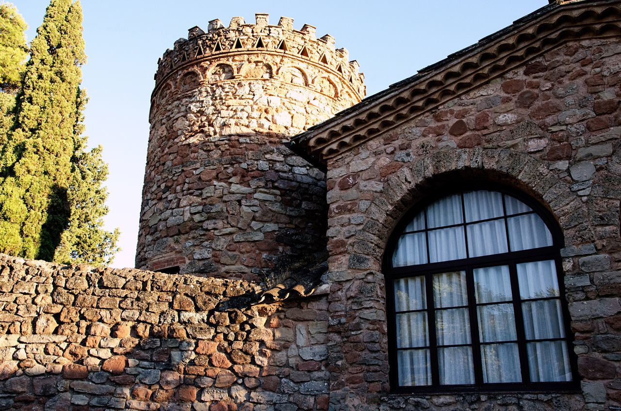 built structure, architecture, window, building exterior, history, the past, low angle view, sky, wall, building, stone wall, nature, day, old, no people, clear sky, wall - building feature, sunlight, brick wall, ancient, brick, outdoors, ancient civilization