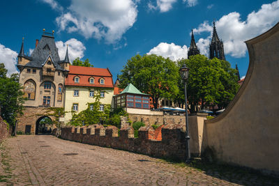 Panoramic view of trees and buildings against sky