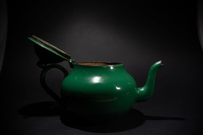 Close-up of tea cup against black background