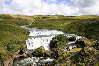 Scenic view of landscape against cloudy sky