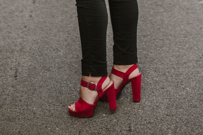 Low section of woman standing on street