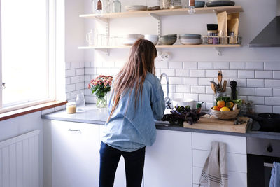 Midsection of woman eating food at home