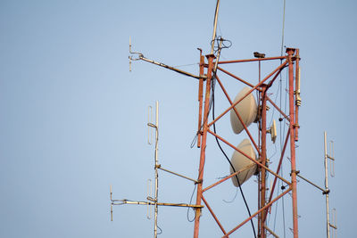 Low angle view of telephone pole against clear sky