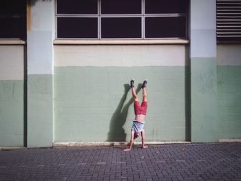 Full length of woman standing on railing