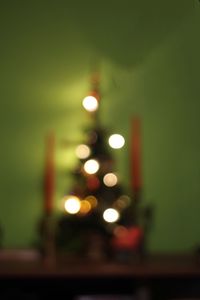 Defocused image of illuminated street light at night