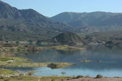 Scenic view of lake and mountains against sky