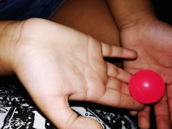 Midsection of woman holding ball