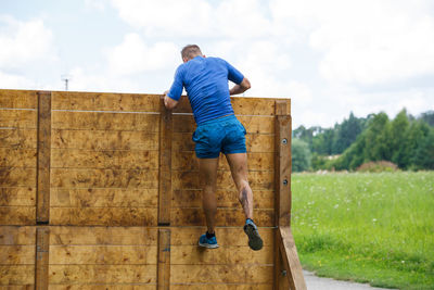 Rear view of man against blue sky