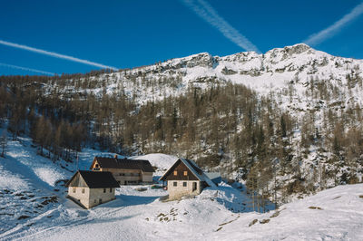 Scenic view of snowcapped mountains against blue sky