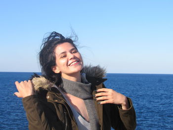 A wonderful day in malta. smiling young woman against sea against clear sky