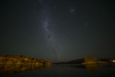 Scenic view of lake against star field at night