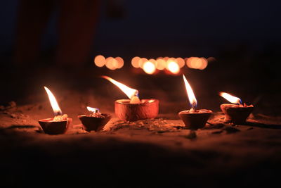 Diyas burning on land at night