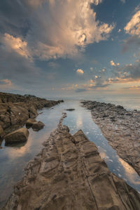 Scenic view of sea against sky at sunset