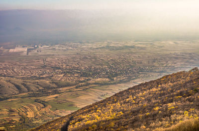 Aerial view of agricultural field against sky