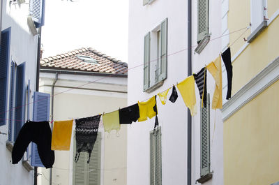 Low angle view of clothes drying against buildings