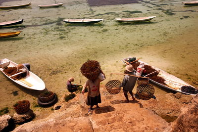 High angle view of people standing on steps at beach