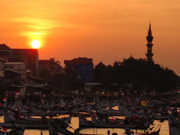 High angle view of buildings in city during sunset