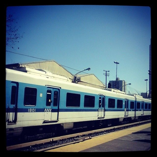 transportation, transfer print, public transportation, railroad track, clear sky, rail transportation, railroad station platform, railroad station, train - vehicle, mode of transport, auto post production filter, built structure, architecture, blue, train, travel, passenger train, building exterior, copy space, sky