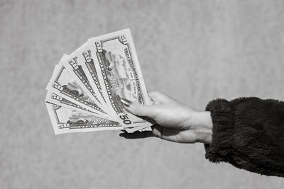 Cropped hand holding paper currency