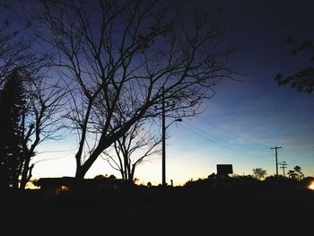 Low angle view of silhouette trees against sky at sunset