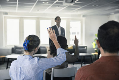 Group of business people attending presentation during conference