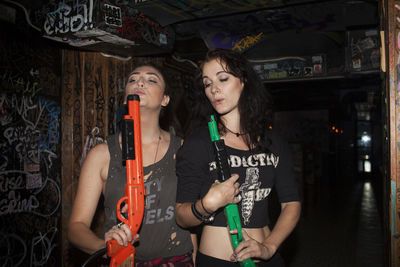 Young women playing with plastic guns