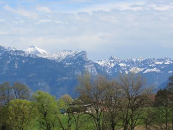 Scenic view of mountains against cloudy sky