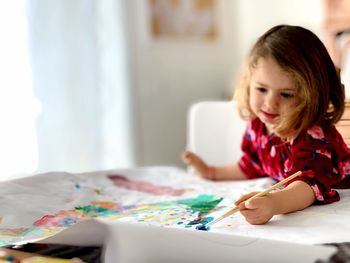 Cute girl on table at home