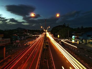 Light trails on road in city at night