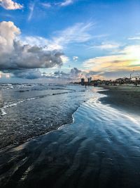 Scenic view of beach against sky during sunset