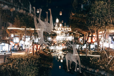 Panoramic view of illuminated park at night