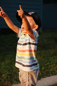 Midsection of boy standing on field