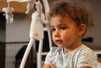 Portrait of cute girl looking away at home