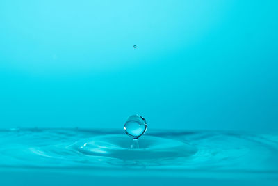 Close-up of drop falling on water surface