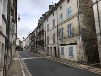 Street amidst buildings in city against sky