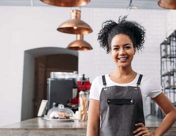 Portrait of young woman standing at home