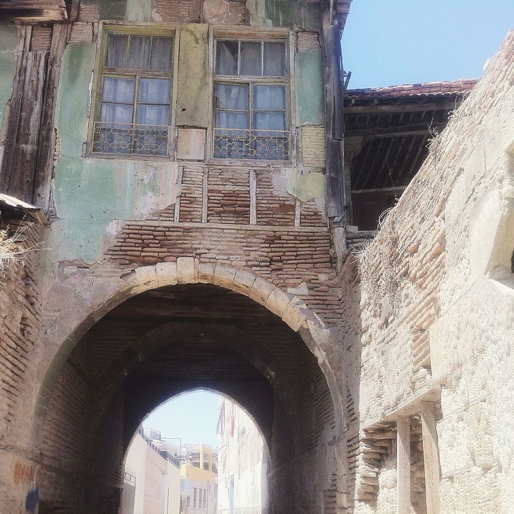 architecture, built structure, building exterior, arch, building, window, day, history, no people, the past, old, outdoors, low angle view, nature, old ruin, city, wall, abandoned, ancient, sky, arched, ruined