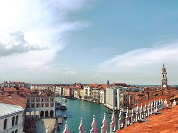 High angle view of buildings against cloudy sky