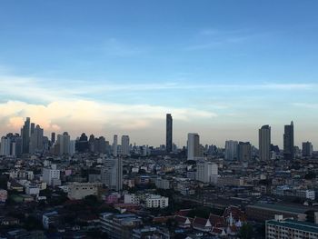 Aerial view of modern buildings in city against sky