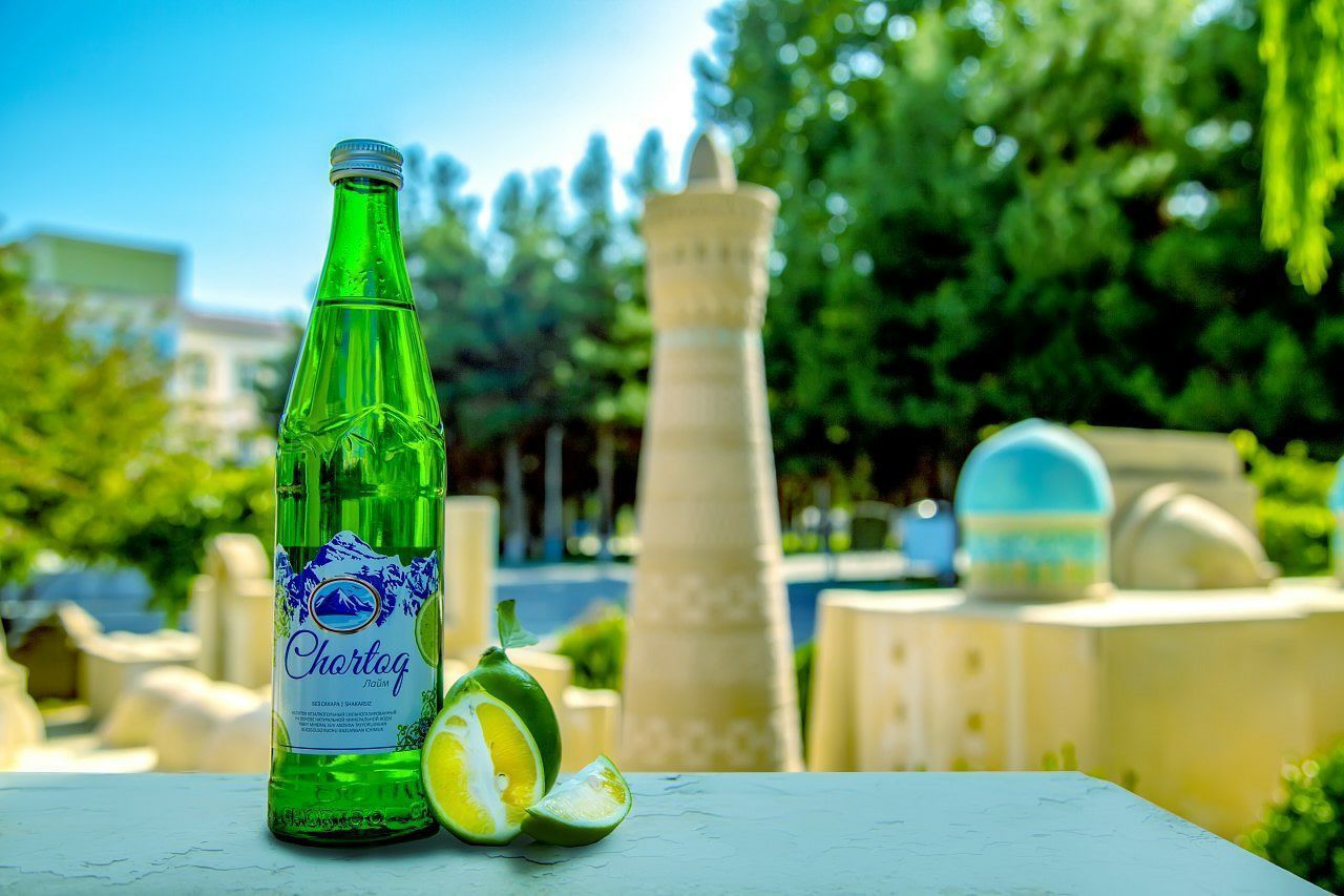 green, bottle, food and drink, nature, container, plant, table, refreshment, drink, focus on foreground, yellow, summer, no people, food, outdoors, day, alcohol, tree, glass, sunlight, sky, lemon, soft drink, drinking glass, freshness