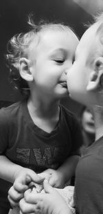 Smiling baby boy looking himself on mirror at home