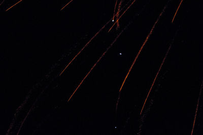 Low angle view of star trails in sky at night