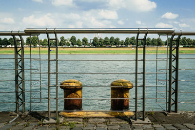 Built structure by sea against sky