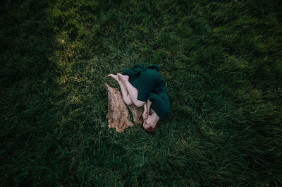 High angle view of woman lying on grass